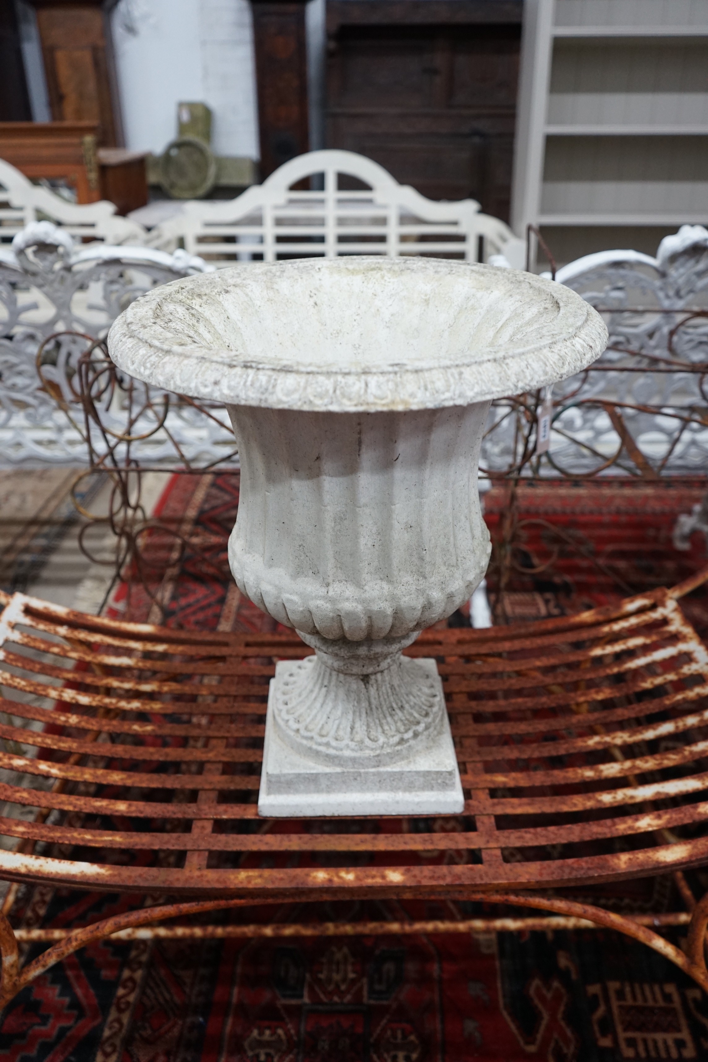 A Victorian earthenware campana garden urn on a plinth base, diameter 64cm, height 90cm